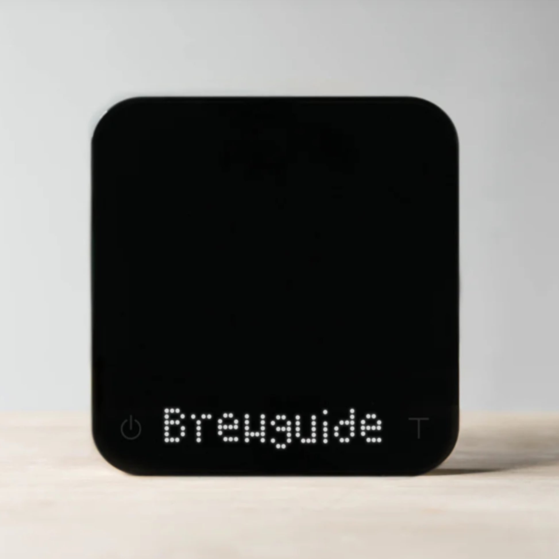 black square scales on their side against a neutral background