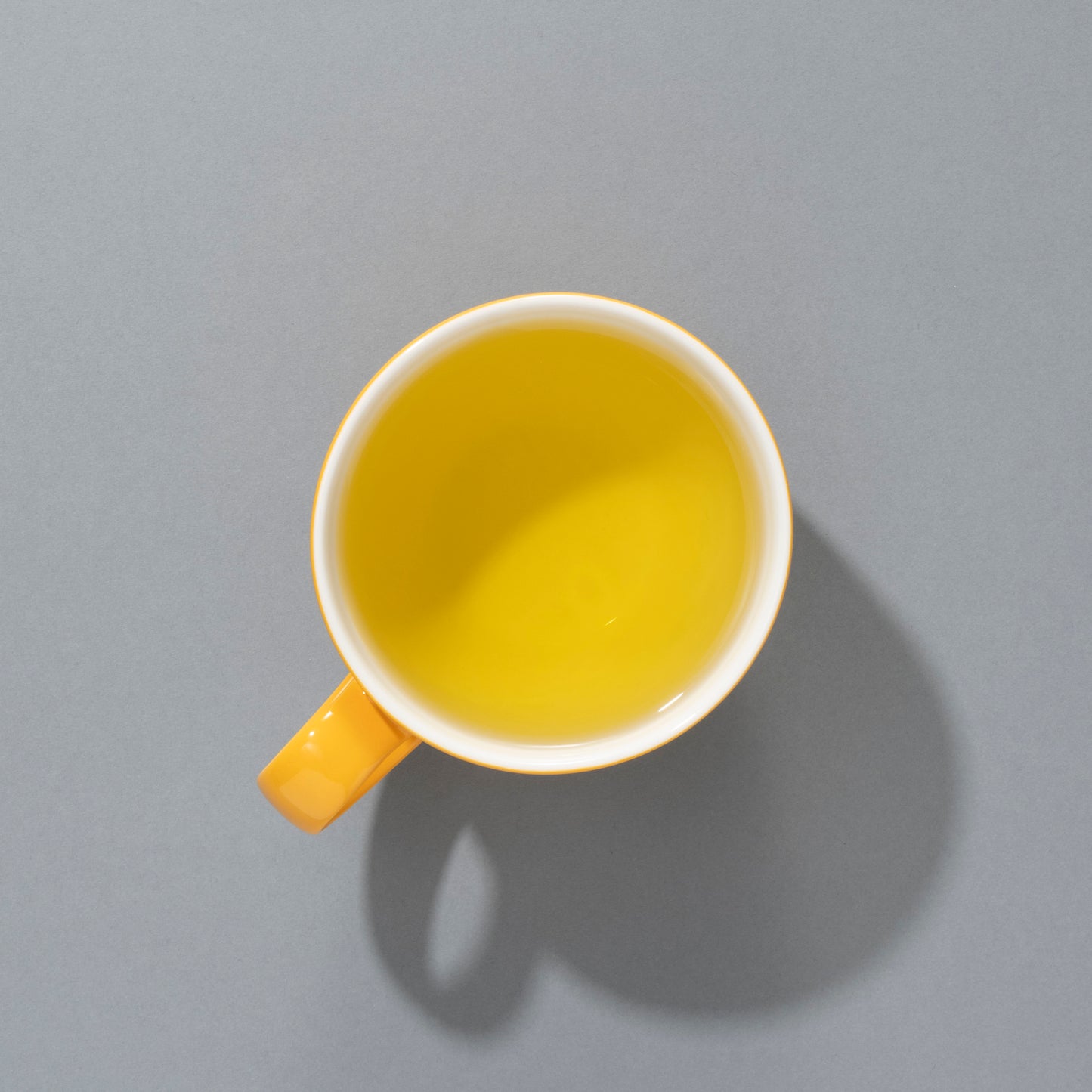 brewed chamomile tea in a yellow cup