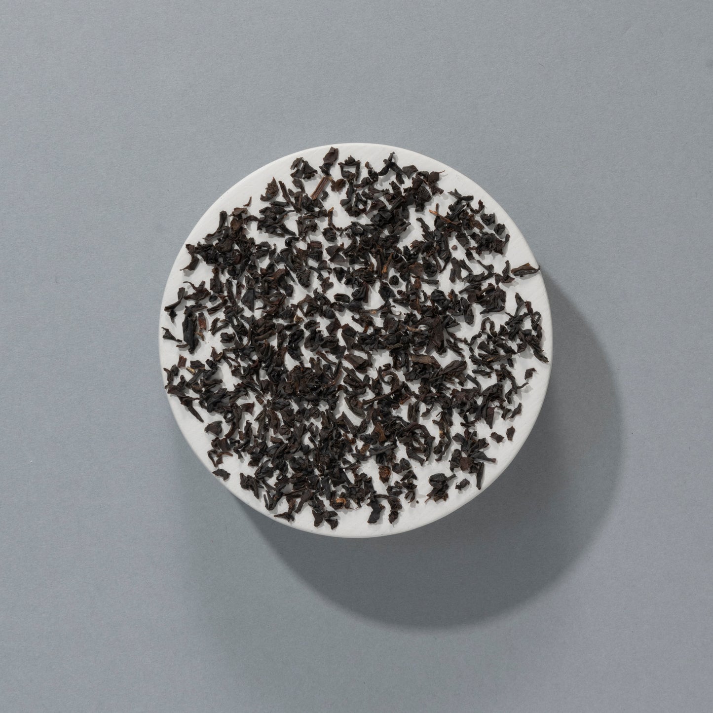 loose leaf black tea on a white platform