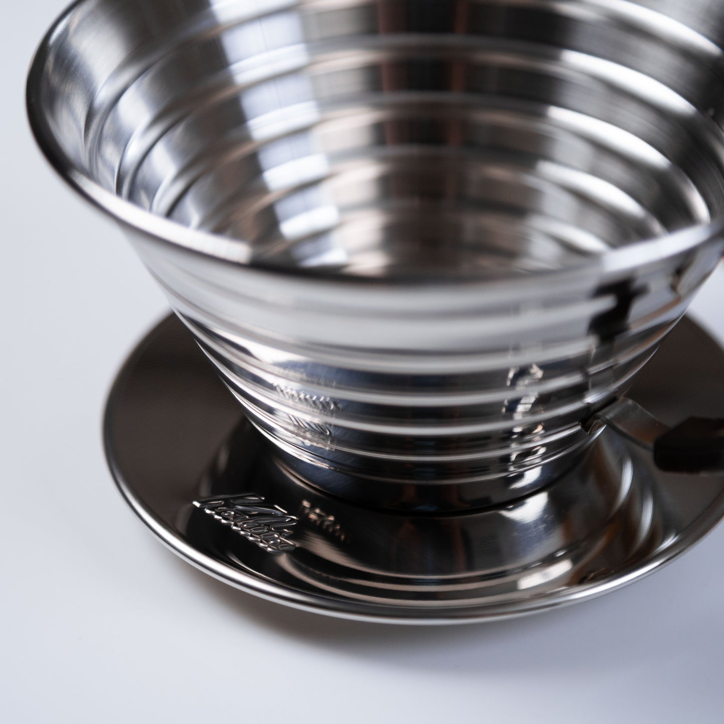 stainless steel kalita dripper on a white surface