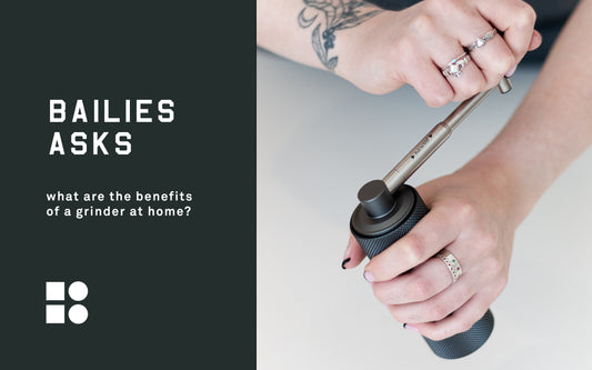 Coffee grinders explained, two hands using a hand held coffee grinder