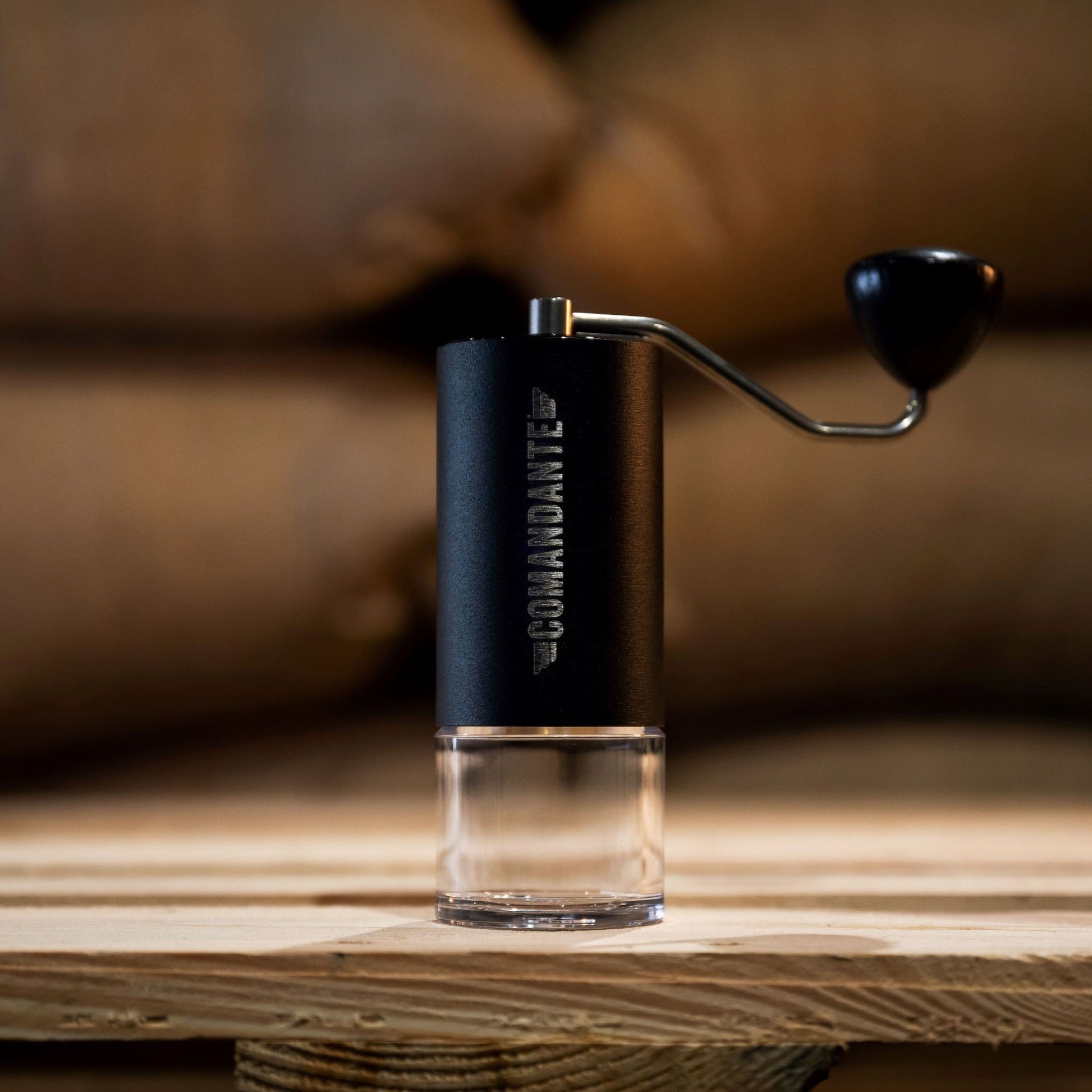Commandante Hand Grinder MK4 against green bean coffee bags